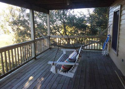 1st level screened in porch that faces the river