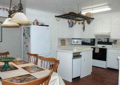 The large Kitchen with center island, tile counters and dining table, seats 6-10